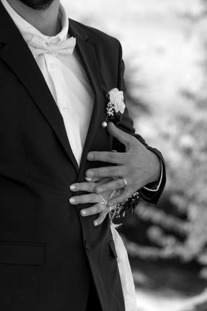Détails mains des mariés pendant leurs photos de couple à leur mariage civil à Montfaucon-Montigné, dans le Maine-et-Loire.
